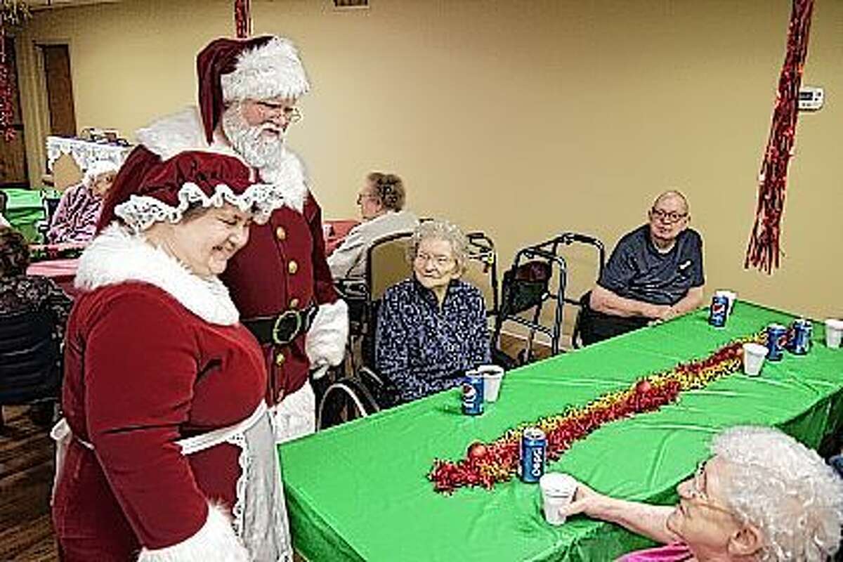 Mr. and Mrs. Claus visit with the seniors Friday at Heritage Health Therapy and Senior Care. The group enjoyed cookies, drinks, Christmas tunes and card games. Staff got festive with an ugly sweater contest and family came to visit their loved ones while getting a pic with old Saint Nick.