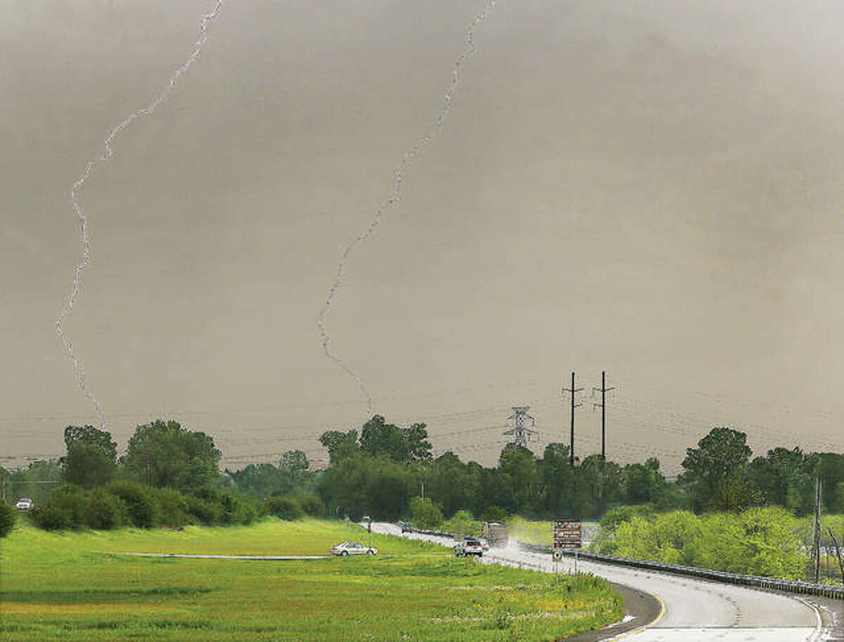 Lightning strikes in two places Friday near the lower lanes of U.S. Route 67 in West Alton, Missouri. The National Weather Service web site is predicting the river to rise 10 feet over the weekend to a level of 27 feet in Alton, nearing the moderate flooding level. That level of water will close Missouri Route 94 and the access road to the Lincoln Shields Recreation Area, both in West Alton.