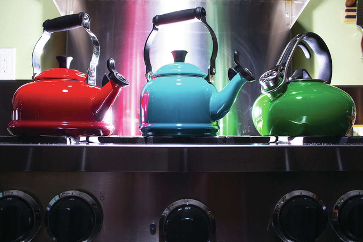 At Mrs. Cook’s at University Village in Seattle, they’ll help you test tea kettles to find one to your liking. Among their options: Le Creuset (from left), classic style in cherry; Le Creuset, demi style in Caribbean; and Chantal, loop style in emerald.
