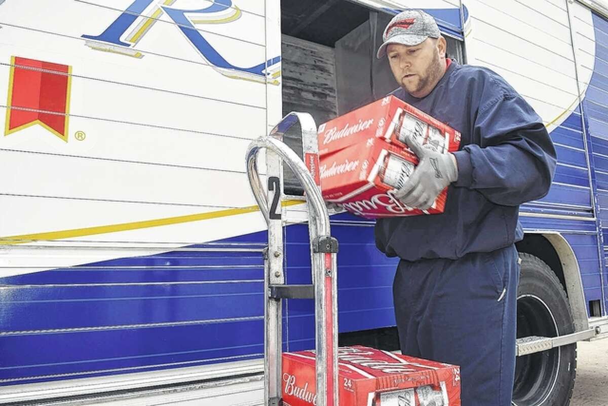 A. Gaudio & Sons driver Phil Pratt unloads cases of beer at Fast Stop on South Main Street in South Jacksonville. The beverage distributor is the key sponsor of the Alert Cab program, which provides free rides home from Jacksonville bars and restaurants for those who have had too much to drink during holiday celebrations.
