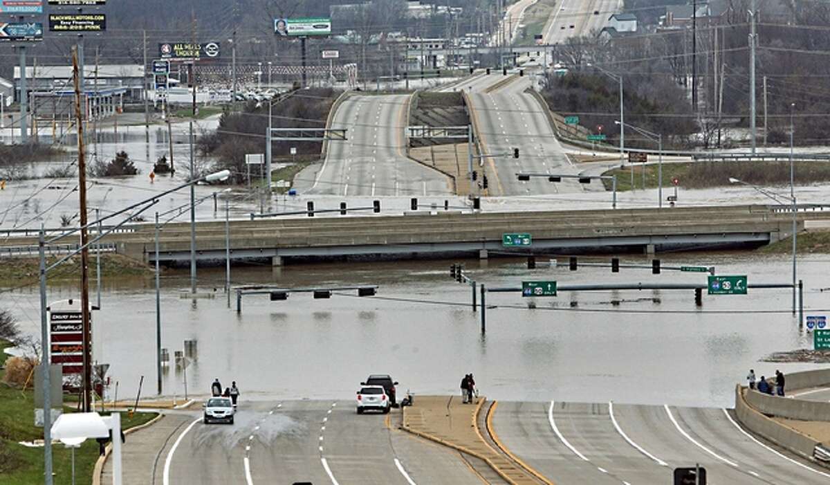 J.B. Forbes | St. Louis Post-Dispatch (via AP) Floodwater from the Meramec River surround the bridge deck of Interstate 44 and Highway 141 in southwest St. Louis County. A rare winter flood threatened nearly two dozen federal levees in Missouri and Illinois as rivers rose, prompting evacuations in several places.