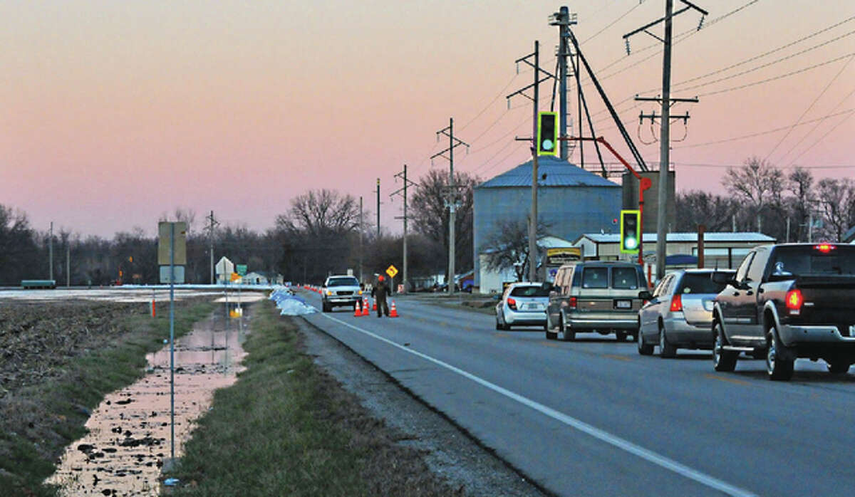 The Sangamon River at Chandlerville laps at Illinois Route 78 on Saturday. Water was rising on the west side of the town and was threatening some houses. Route 78 has been reduced to one lane in some areas.