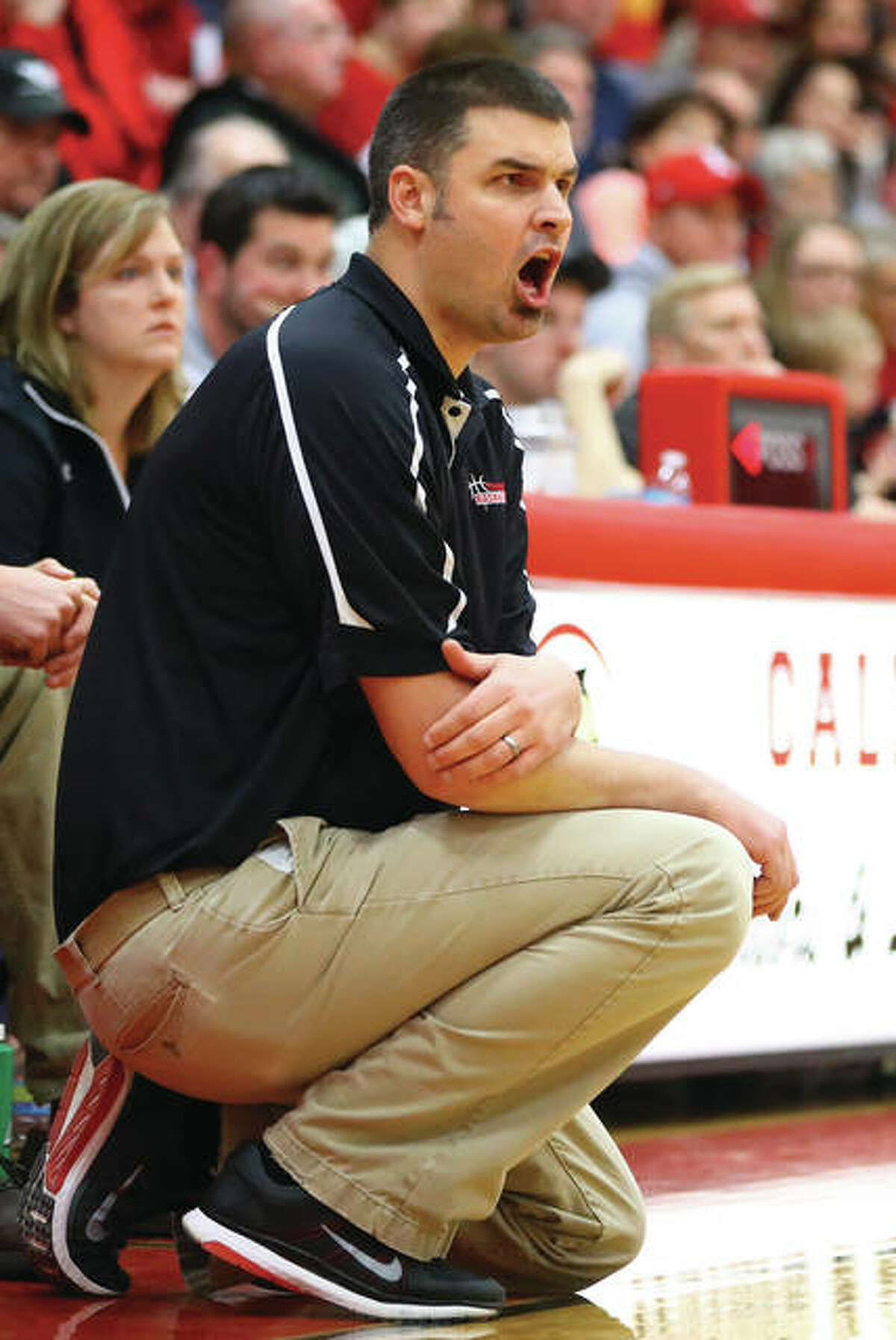 Calhoun coach Aaron Baalman shouts instruction from the bench during the Warriors’ victory over No. 1-ranked Lebanon in the Calhoun Class 1A Sectional title game on Feb. 14 in Hardin. Baalman announced his decision to resign as Calhoun coach after eight seasons produced a 207-49 record with a state title from three state tourney appearances.