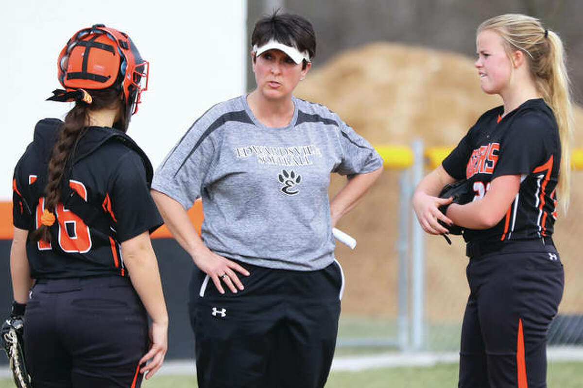Edwardsville coach Lori Blade (middle) meets with catcher Taryn Brown (left) and pitcher Jordan Garella in the pitcher’s circle during a break in the Tigers’ victory March 20 in Gillespie.