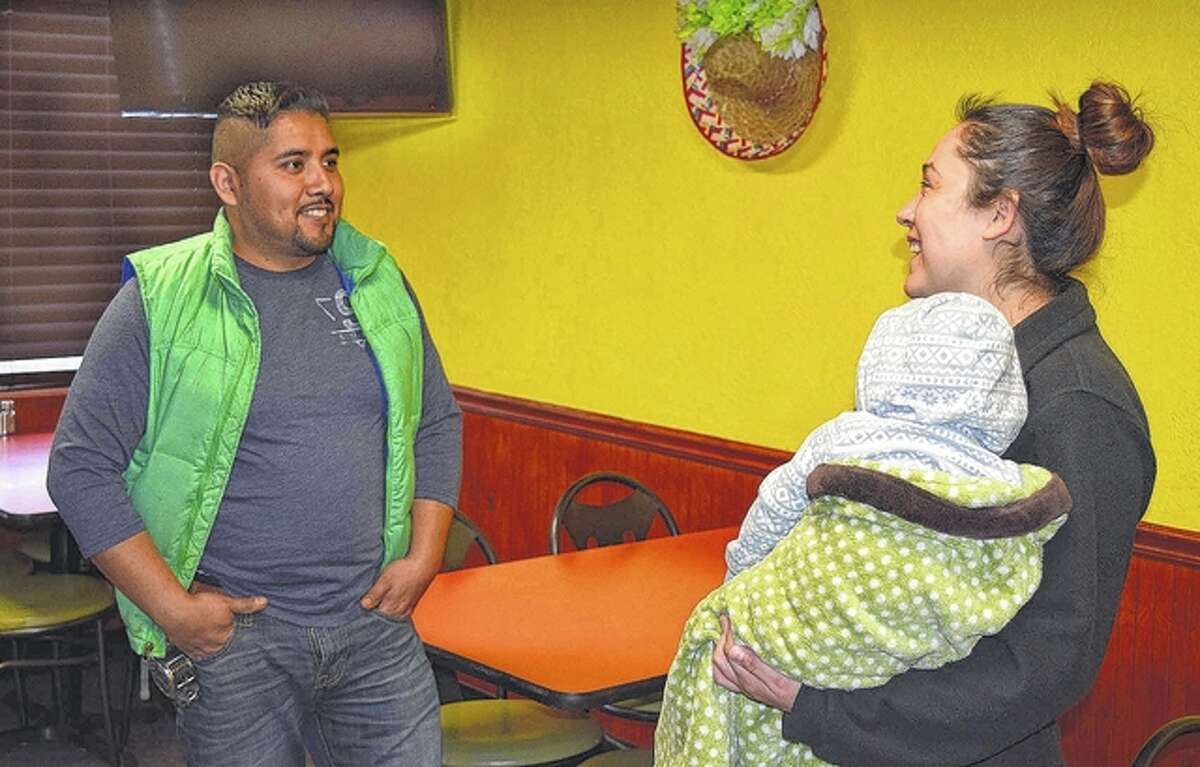 Hector Alvarado (left) talks with his wife, Neri Hernandez, and their 7-month-old son, Hugo, at their new Mexican restaurant, Little Mexico, which is scheduled to open next month at 2001 W. Morton Ave.