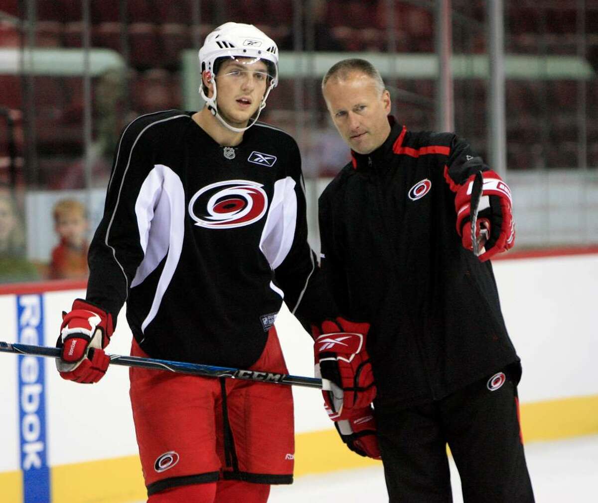 Brett Carson, left, gets some direction from coach Tom Barrasso during the Hurricanes' practice at the RBC Center in Raleigh, N.C. (Chris Seward/News&Observer)