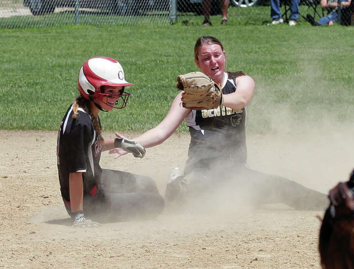 Calhoun’s Abby Baalman and Camp Point Central shortstop Kennedy Marlow look to an ump for the call at second base with two outs in the eighth inning of the Calhoun Class 1A Sectional title game. Baalman was called safe and Calhoun plated the winning run on the play.