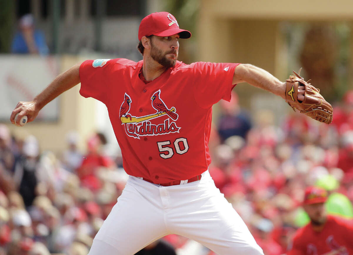 Cardinals pitcher Adam Wainwright throws during the first inning of a spring training game against the New York Mets on Monday in Jupiter, Fla.