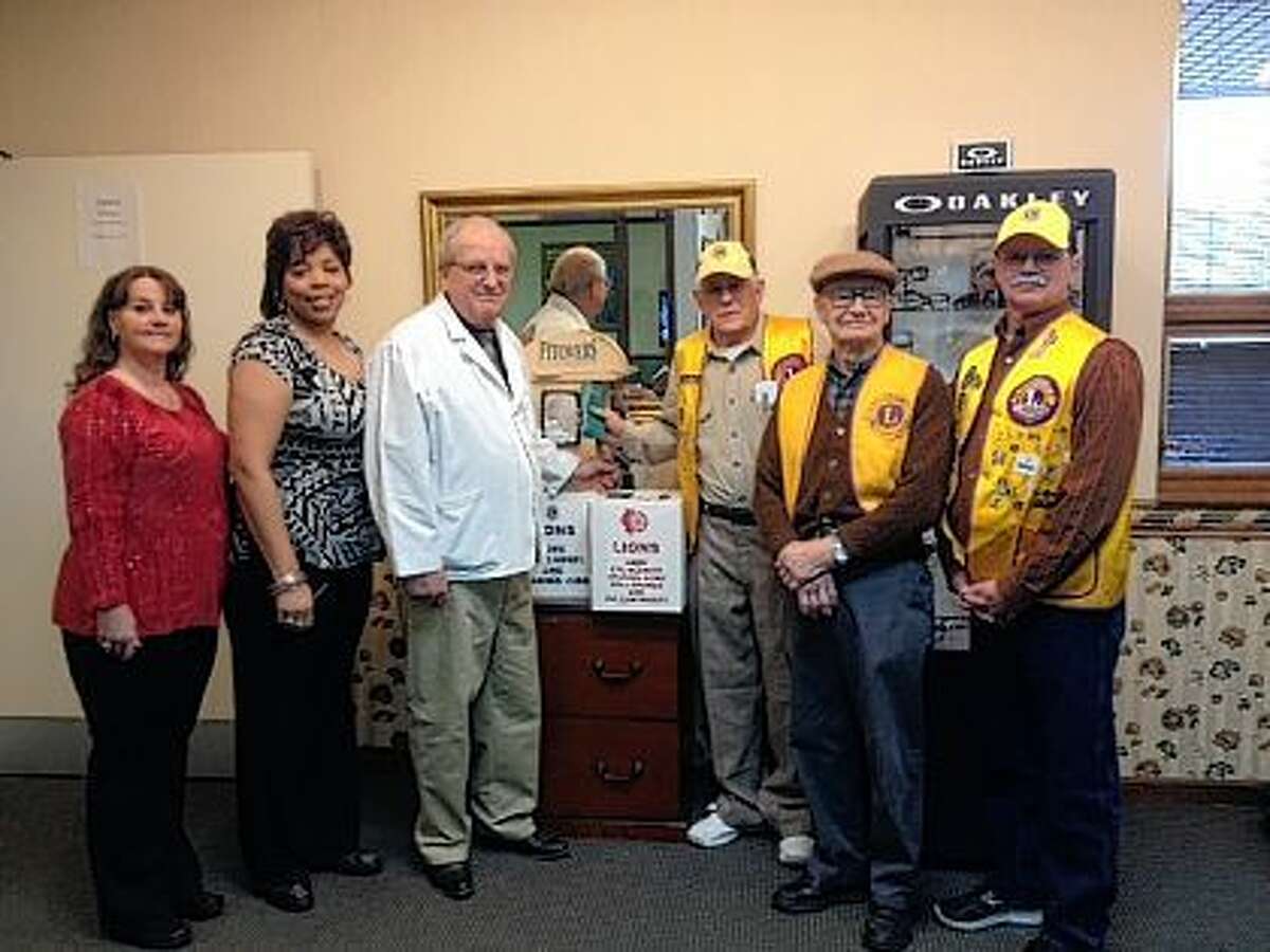 Prairie Eye Center optical department staff Jerrie Stewart (from left), Jackie Killion and Larry Massey congratulate Jacksonville Lions Club members Nick Farrar, Floyd Anderson and Dan Scholfield on receiving their 50,000th pair of eyeglasses. The Lions Club distributes glasses to people around the world.