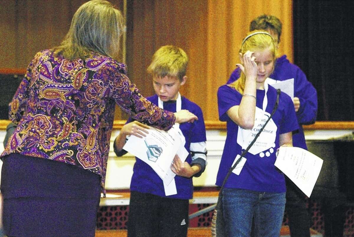 Cody Boys, a sixth-grader at the Illinois School for the Visually Impaired, and Elissa Edwards, a fifth-grader at Metcalf School in Bloomingtonm, receive awards during the Braille Challenge regional competition Friday. Boys placed third in the sophomore division; Edwards place second. The event was held at ISVI.
