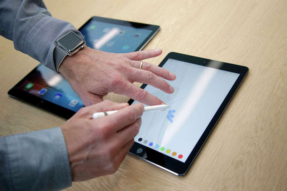 In this Monday, March 21, 2016, file photo, members of the media and invited guests take a look at the new iPad Pro during an event at Apple headquarters in Cupertino, Calif. Tablets may never be the consumer sensation they once were, but they are finding new life among professionals. Microsoft made a bet on this market with the Surface business. Now, Apple is expanding that push with a second iPad Pro model, while Samsung launched its own. These new tablets, with higher price tags, appeal to people looking for productivity.