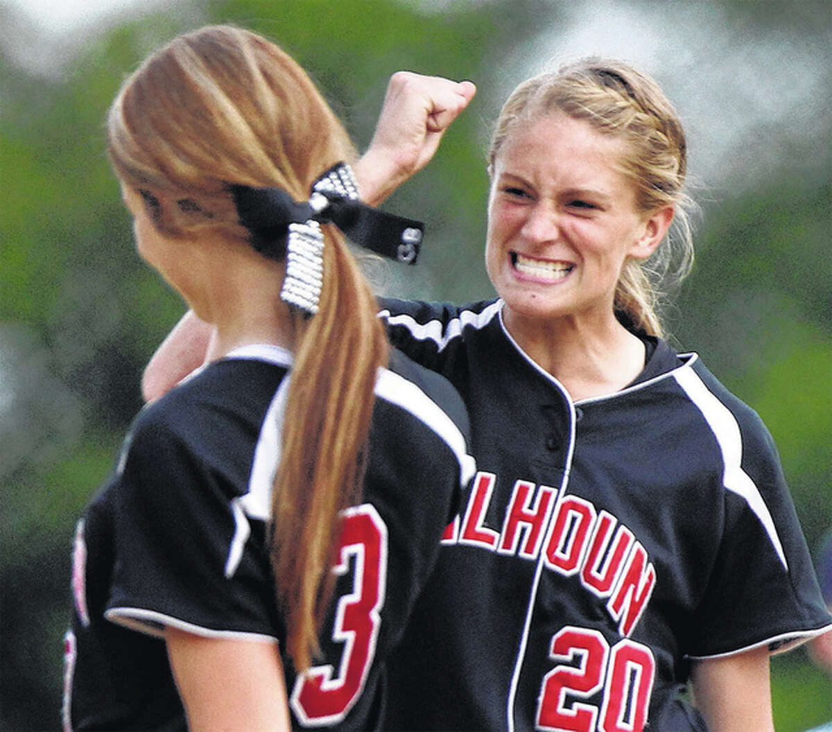 Calhoun third baseman Emma Baalman (right) congratulates pitcher Grace Baalman after a Warriors win in the 2015 Class 1A state tournament in East Peoria. Both return from a 34-4 state championship team ranked No. 1 in the state and seeking back-to-back titles.