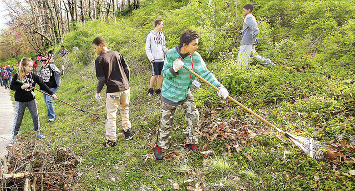 Some of the students used rakes and hoes to clear the weeds and honeysuckle, which has almost taken over the hillside. Teachers and some administrators also joined in the work detail.