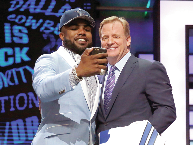 Ohio State running back Ezekiel Elliott holds his jersey after being  selected by the Dallas Cowboys with the fourth overall pick in the 2016 NFL  Draft on April 28, 2016 in Chicago.