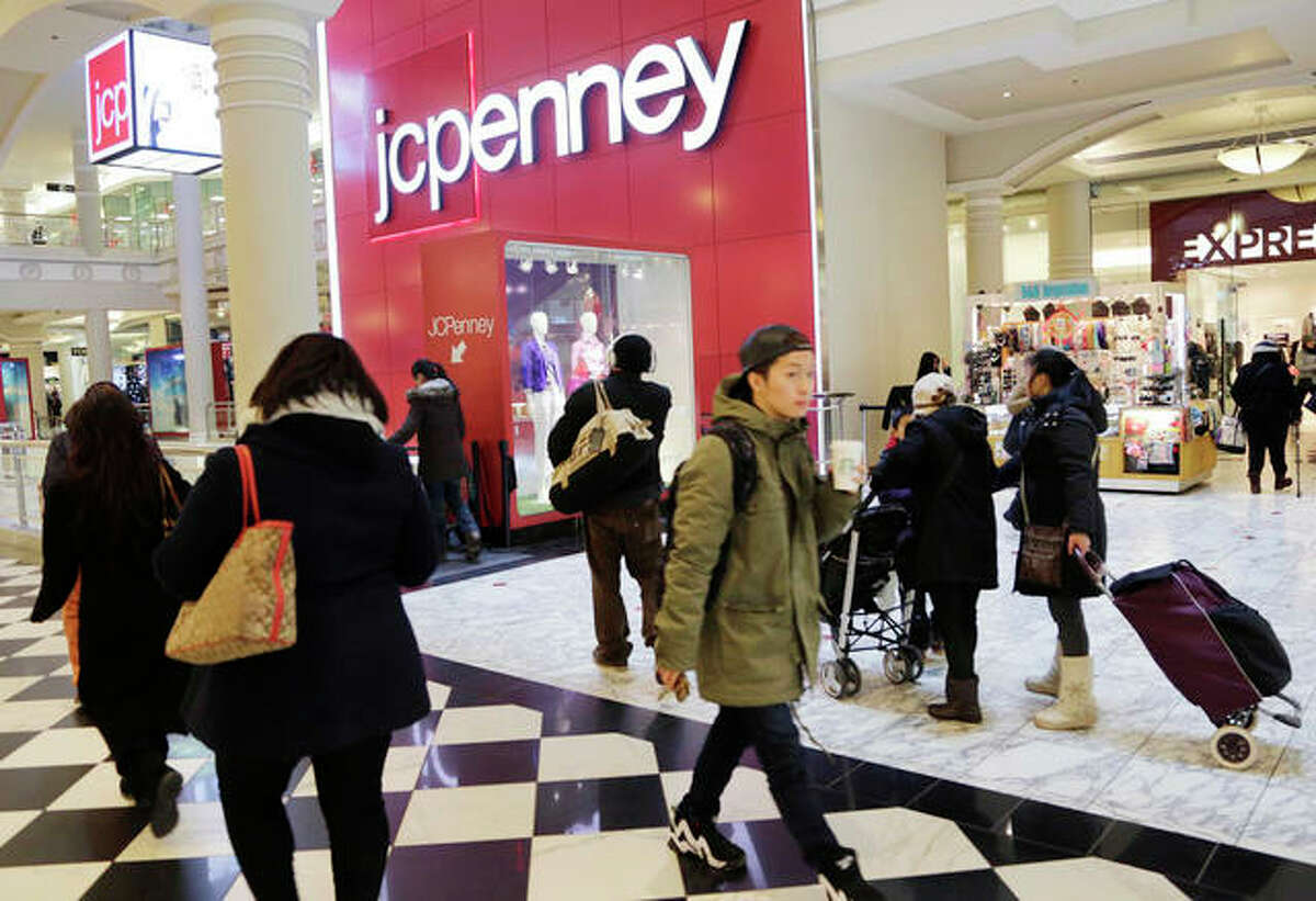 In this file photo, shoppers visit a J.C. Penney store in New York. The Texas-based retailer reports financial results, Friday.
