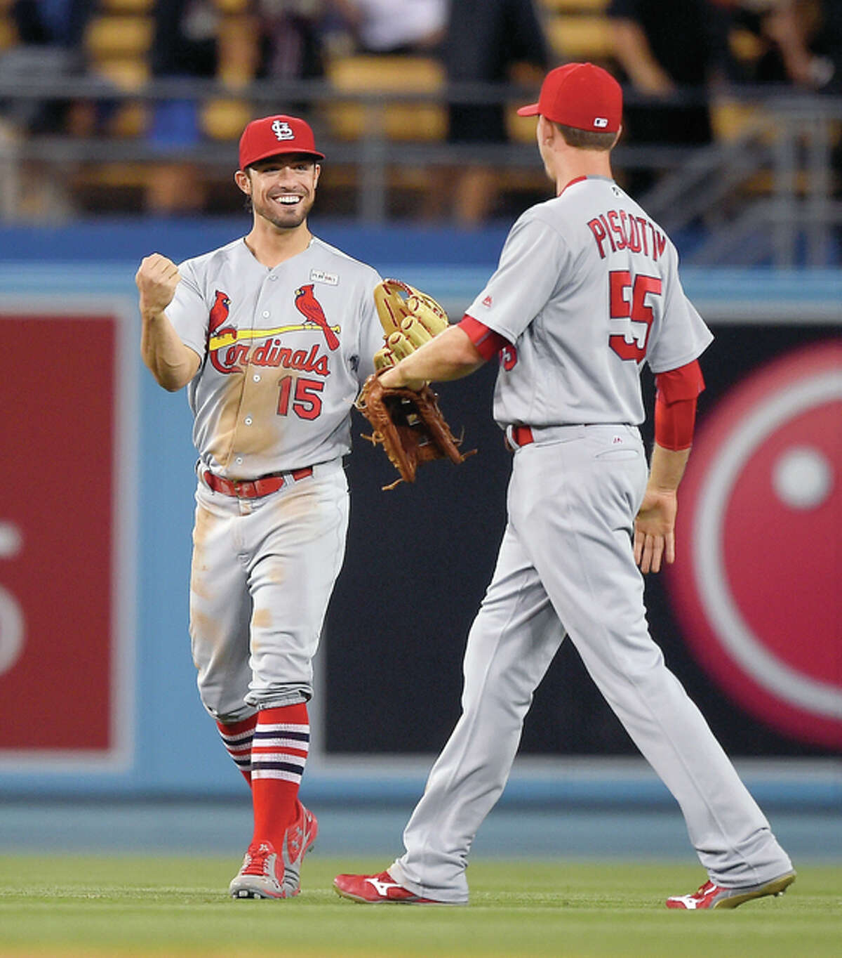 The Cardinals’ Randal Grichuk, left, and Stephen Piscotty congratulate each other after their team’s 5-2 win over the Los Angeles Dodgers Sunday night in Los Angeles.