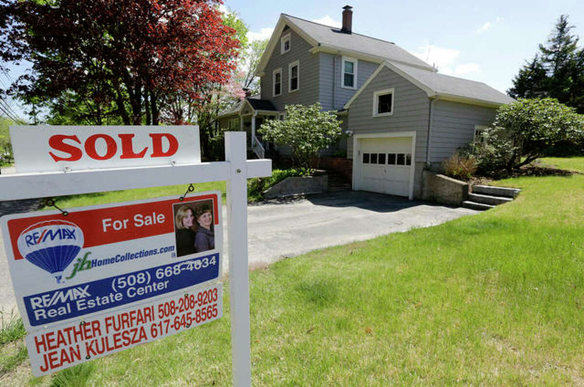 This Wednesday, May 18, 2016, photo shows a “Sold” sign in front of a house in Walpole, Mass. On Friday, May 20, the National Association of Realtors reports on sales of existing homes in April.