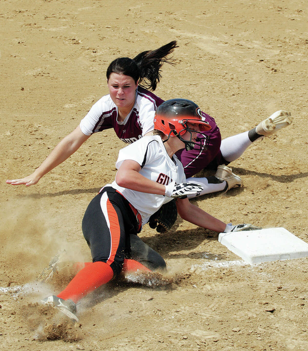 Dupo’s third baseman Taylor Esmon (back) tags out Gillespie’s Rylee Jarman after Jarman tried to advance on a flyball during the fourth inning Saturday in the Gillespie Class 2A Sectional championship game.