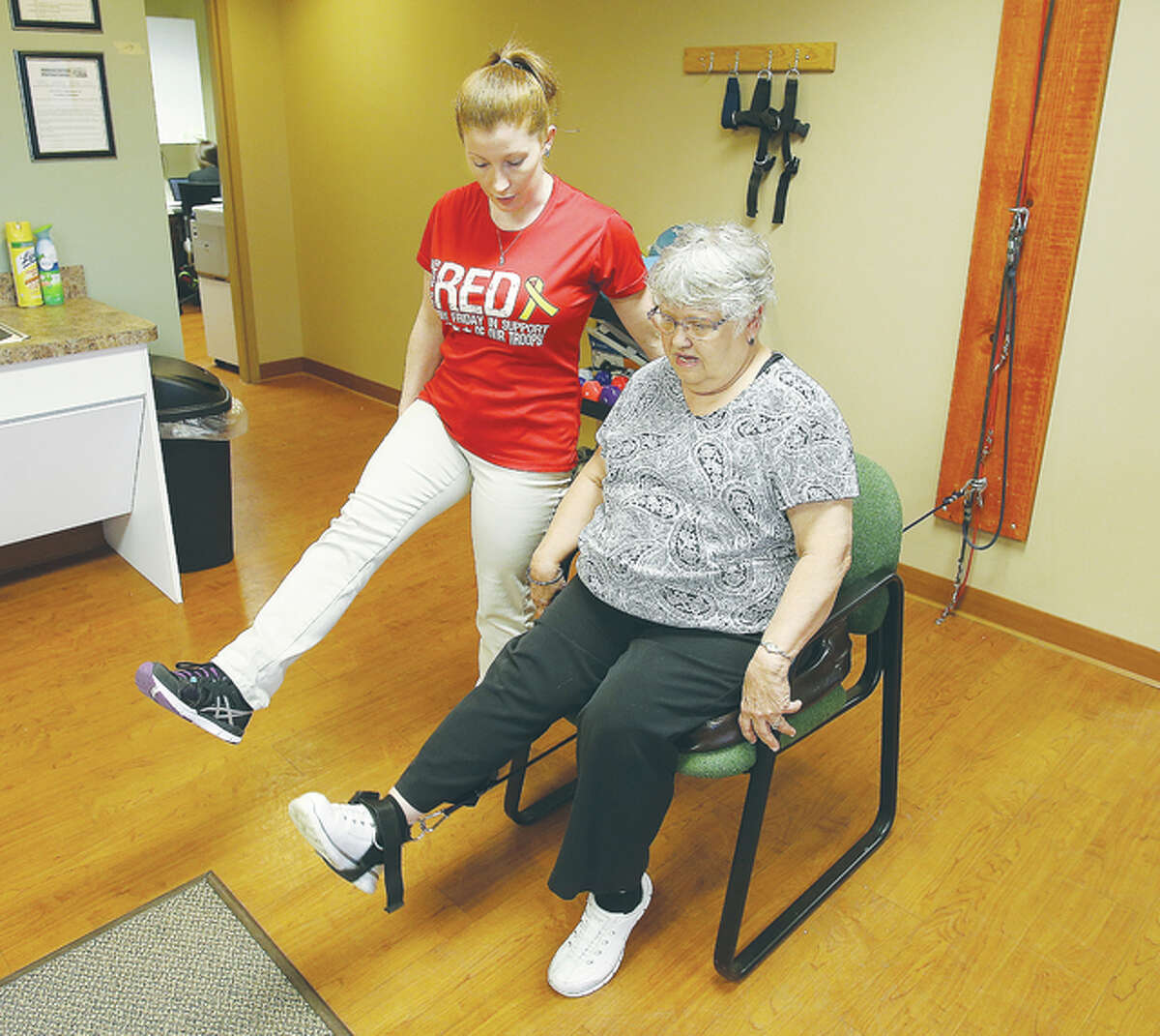 Physical therapy is a vital part of the treatment process at the Associated Physicians Group in Edwardsville. Here Physical Therapy Assistant Sara Aleandri, left, works with patient Bonnie Seitz to do leg lifting with an ankle weight.