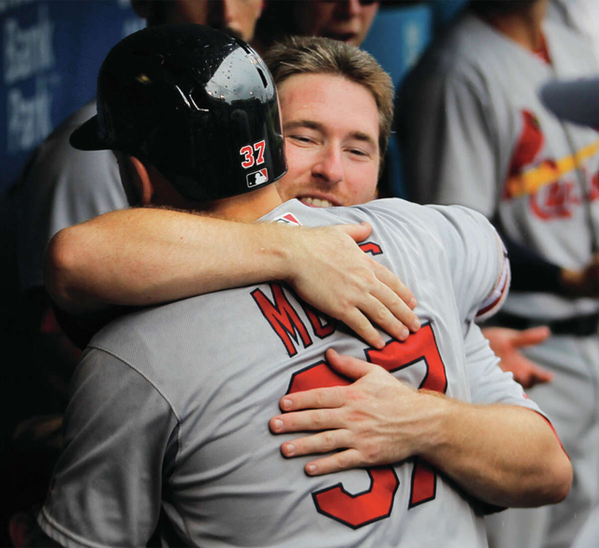 The Cardinals Brandon Moss is embraced by teammate Jedd Gyorko (facing) after Moss homered in the fourth inning Sunday in a win over the Phillies in Philadelphia.