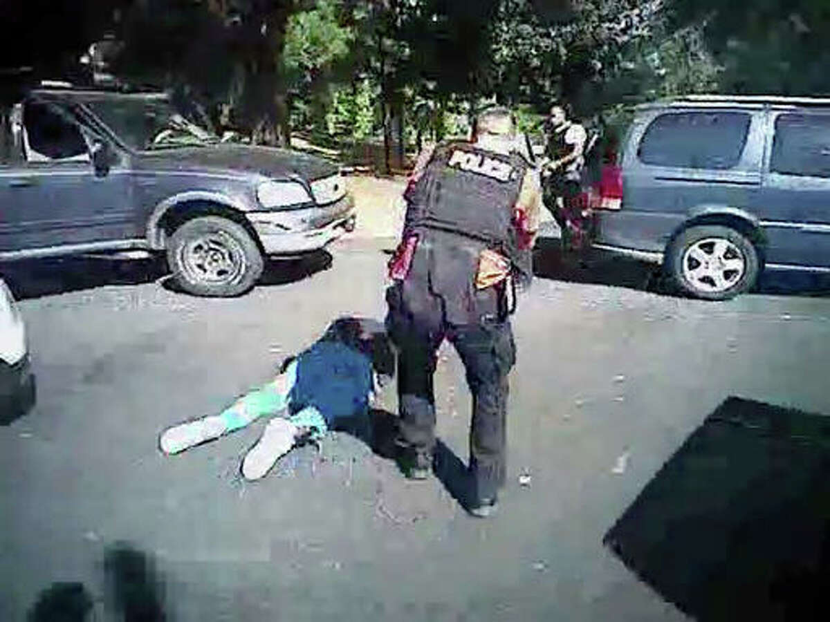 This image made from video provided by the Charlotte-Mecklenburg Police Department on Saturday, Sept. 24, shows Keith Scott on the ground as police approach him in Charlotte, North Carolina, on Sept. 20.