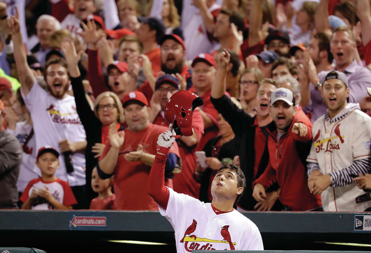 The Cardinals’ Aledmys Diaz tips his cap and looks skyward after hitting a grand slam during the fourth inning Tuesday night against the Cincinnati Reds at Busch Stadium. Diaz was childhood friend Jose Fernandez, the Miami Marlins pitcher killed in a boating accident Sunday.