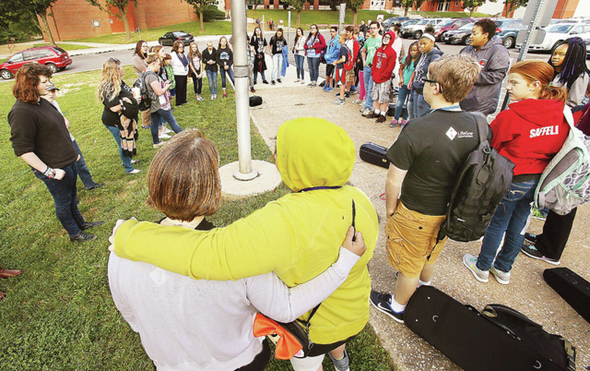 Some of about 45 Alton Middle School students gather for prayers and song around the school flagpole early Wednesday on the annual “See You At The Pole” day of prayer observed by several schools in our area each year. Students and faculty say personal prayers, often about topical events in the news, and sing or listen to music before the start of the school day.