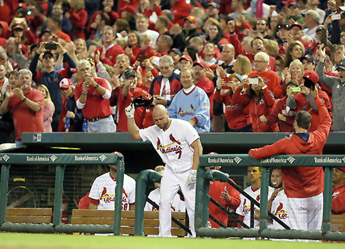 The Cardinals’ Matt Holliday obliges the fans with a curtain call after hitting a solo home run during the seventh inning against the Pittsburgh Pirates Friday at Busch Stadium.