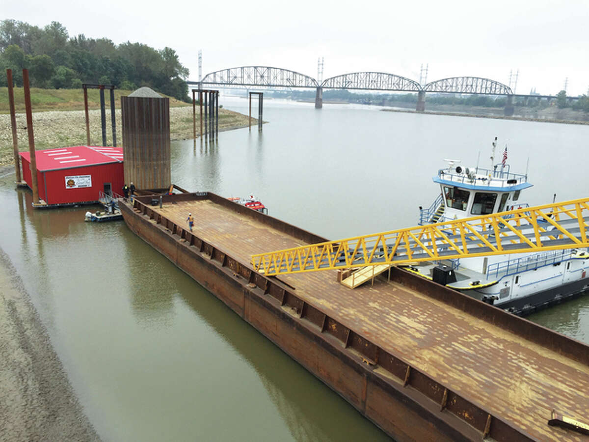 A ramp at America’s Central Port’s new South Harbor extends onto a barge connected to the building that will dock a Madison County fire boat. A tug boat, right, called a “push boat” by river workers, is anchored. Tours of the facility were offered during a dedication ceremony Monday.