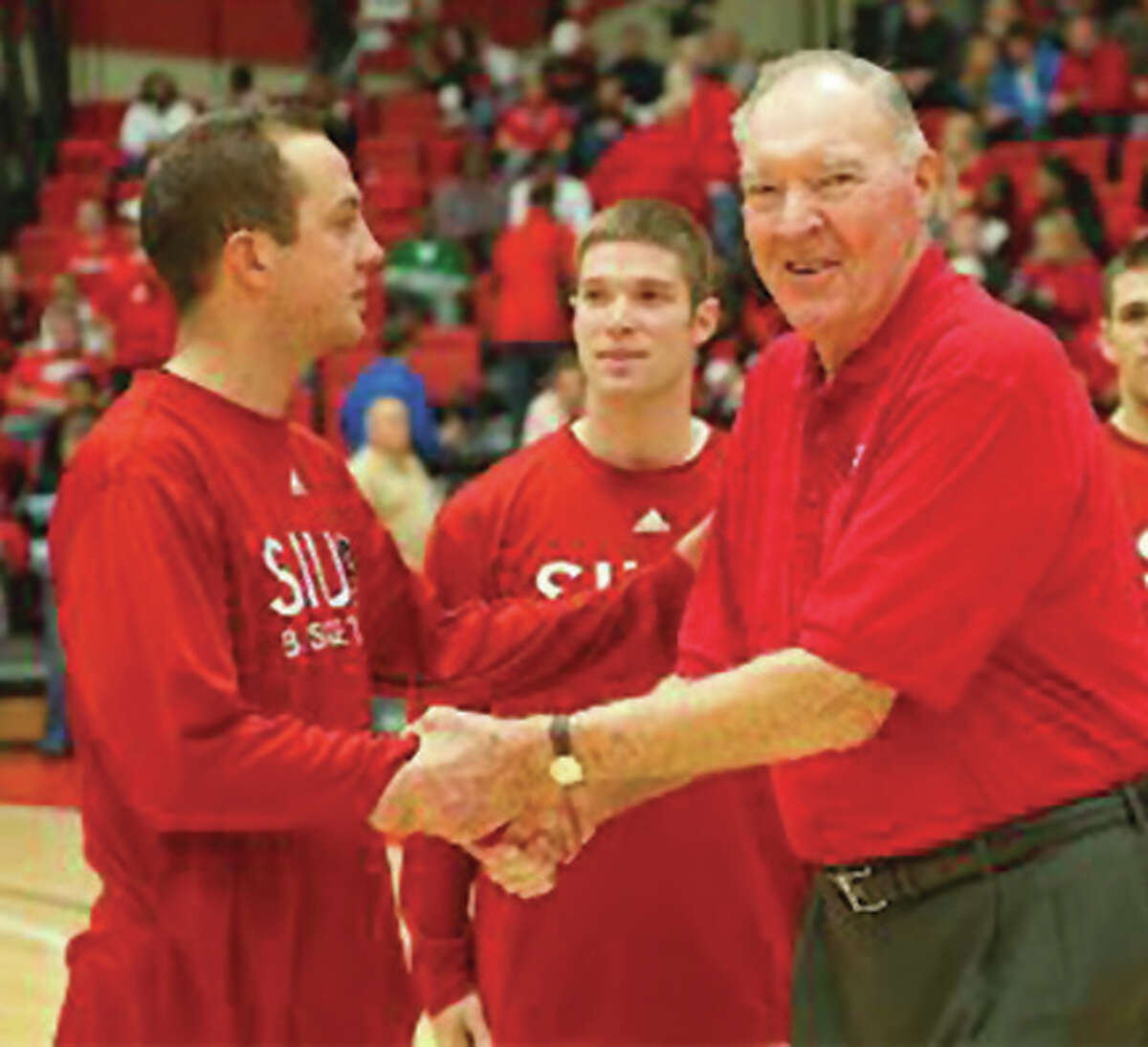 Basketball Hall of Famer Harry Gallatin (right) greets SIUE players Dane Church (left) and Stephen Jones (center) during a ceremony during the 2008-09 season at Vadalabene Center in Edwardsville. Gallatin, a Roxana native and SIUE Hall of Famer, died Wednesday at age 88.