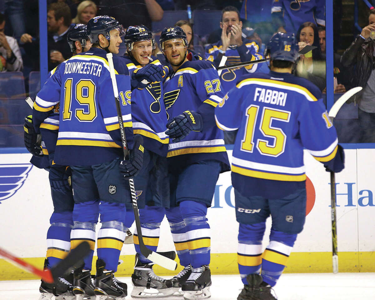 The Blues’ Dmitrij Jaskin (23) is congratulated by teammates Jay Bouwmeester (19), Alex Pietrangelo (27) and Robby Fabbri (15) after scoring a goal against the Chicago Blackhawks in a Blues preseason victory Oct. 1 in St. Louis. The Blues open the 2015 season Thursday night at home against the Edmonton Oilers.