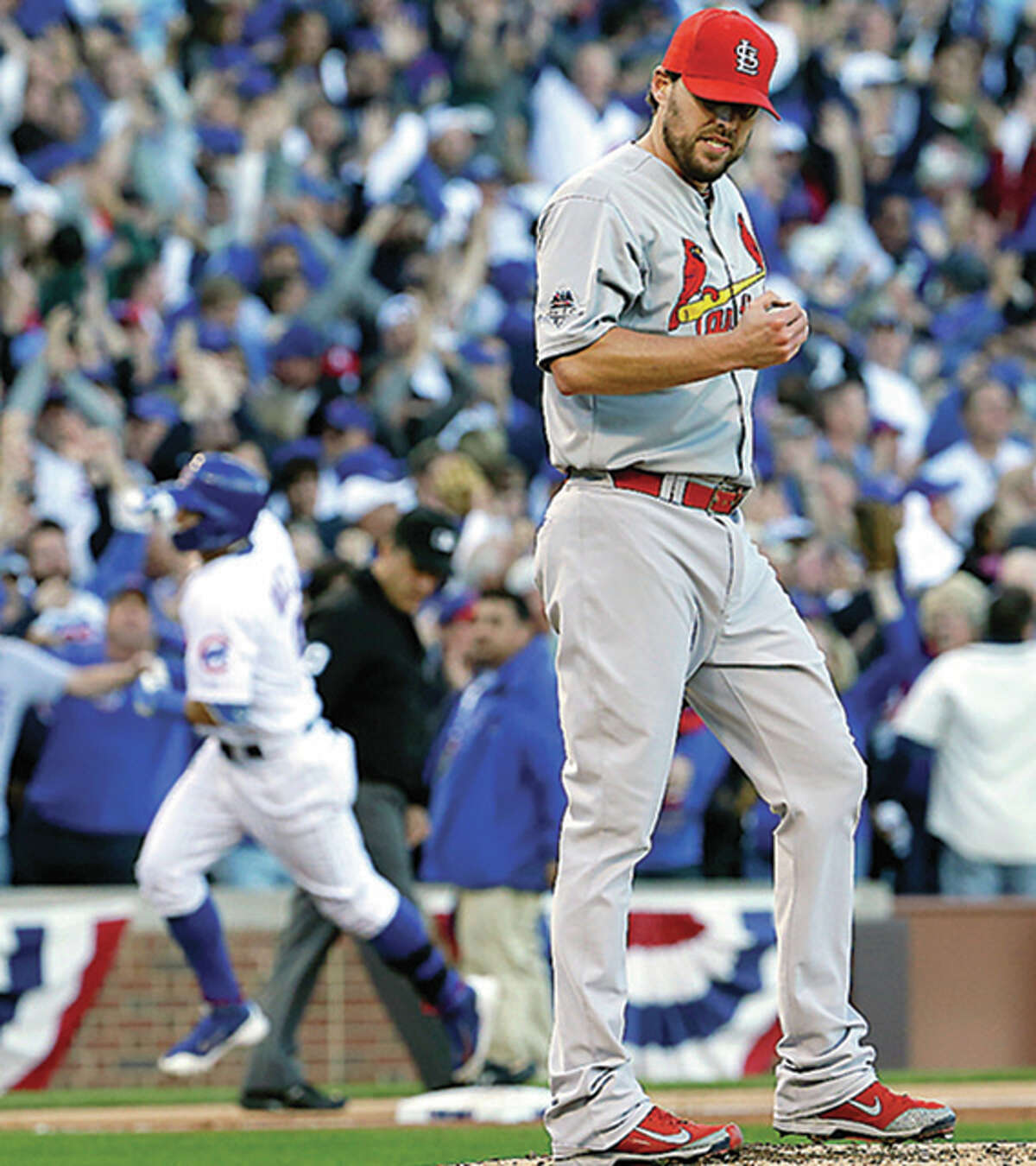 Cardinals starter John Lackey reacts after giving up a three-run home run to the Cubs’ Javier Baez in the second inning Tuesday at Wrigley Field.