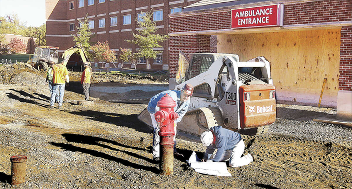 The emergency entrance for ambulances is being widened and lengthened to accommodate the large Children’s Hospital ambulance and Alton Memorial’s own fleet. Workers were looking over blueprints Tuesday that apparently call for the fire hydrant to be moved closer to the roadway to make more room for the large rigs.