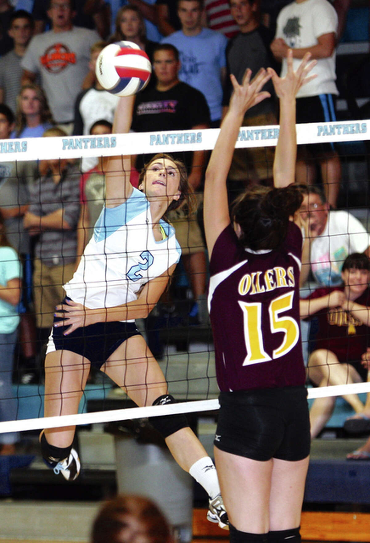 Jersey’s Mackenzie Thurston (left), shown hitting past the block of EA-WR’s Lexie Johnson during a Jersey win Sept. 3 in Jerseyville, was an all-tournament selection while helping to Panthers to a 4-0 record and the tite at Saturday’s Jersey Tourney at Havens Gym.