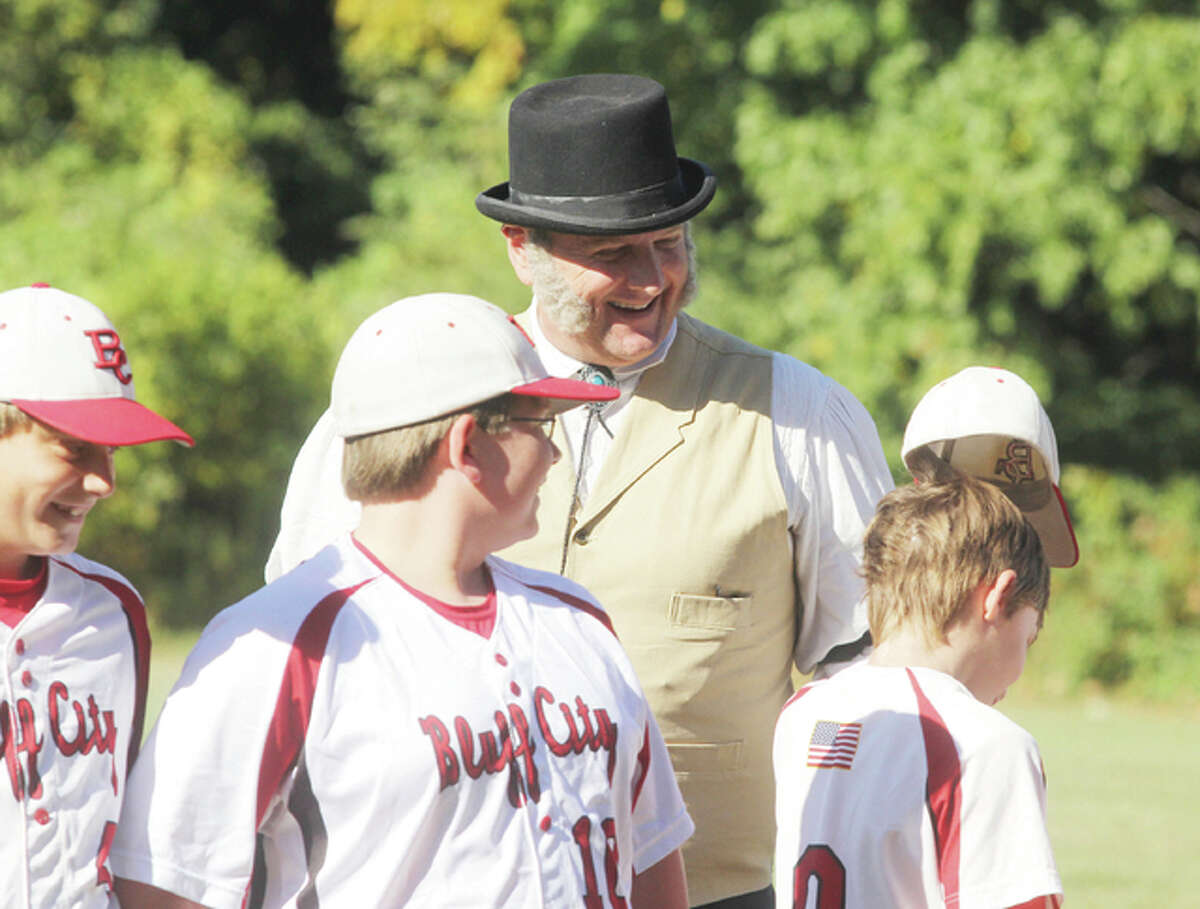 “Honest” Al Stare, of Jacksonville, watches as members of the Bluff City Select 12 years old and under team introduce themselves prior to a game of 1858 rules baseball Saturday at Rock Spring Park. Stare served as the arbitrator (later known as an umpire) for the game against combined members of the Springfield Long Nine and the St. Louis Brown Stockings teams. The adult team defeated the boys’ team by approximately 6-0 (they forgot to keep score the first few innings).