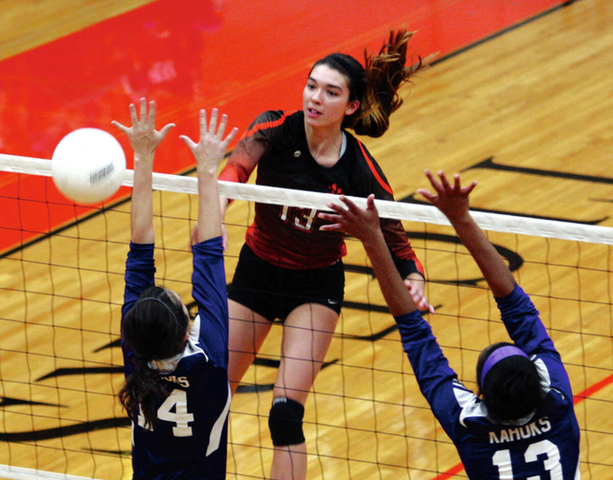 Edwardsville’s Annie Ellis hits past the block put up by the Collinsville Kahoks in a Tigers win Oct. 1 in Edwardsville. The Tigers were on the road Monday night and Ellis keyed a rally that wiped out a 22-13 Mater Dei lead and Edwardsville posted a two-set win in Breese.