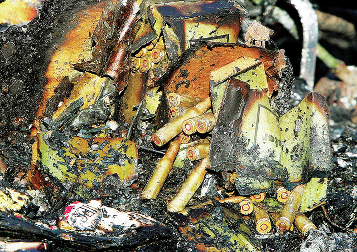 Unexploded ammunition lays in the remains of the fire. A neighbor said they were awakened by popping sounds, looked out their window and said the whole sky was orange with flames. Wind gusts may have helped the fire spread, melting siding and an above-ground swimming pool in an adjacent yard.