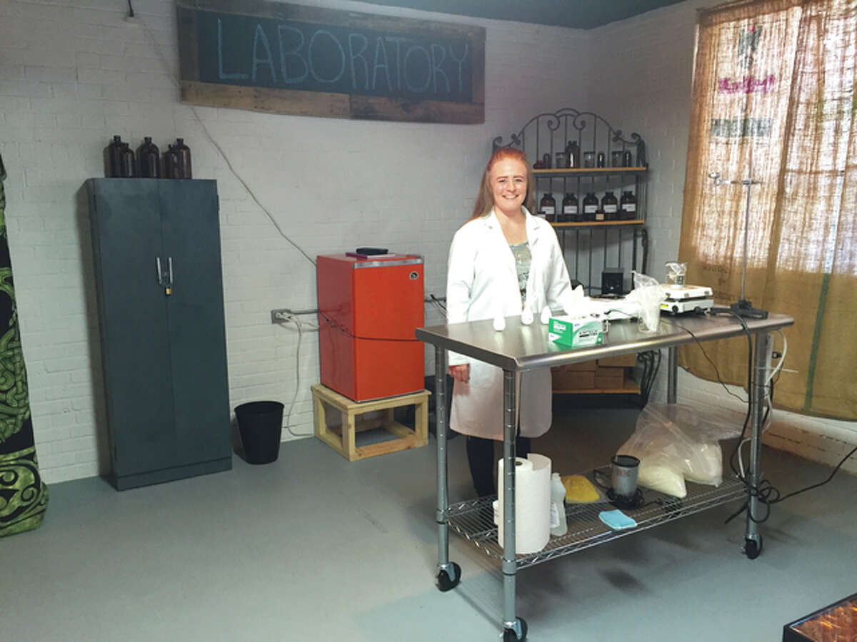 Orb Elements owner Lora Ruppert-Aulabaugh poses in her aromatherapy laboratory in the old Milton Schoolhouse.
