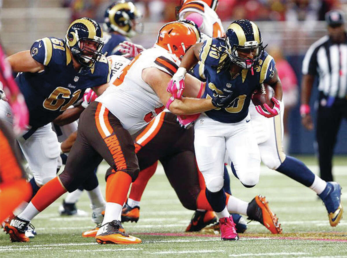 Rams running back Todd Gurley breaks through the tackle of a Browns tackler on his way a third straight 100-yard rushing game in Sunday’s victory over the Cleveland Browns at the Edward Jones Dome in St. Louis.