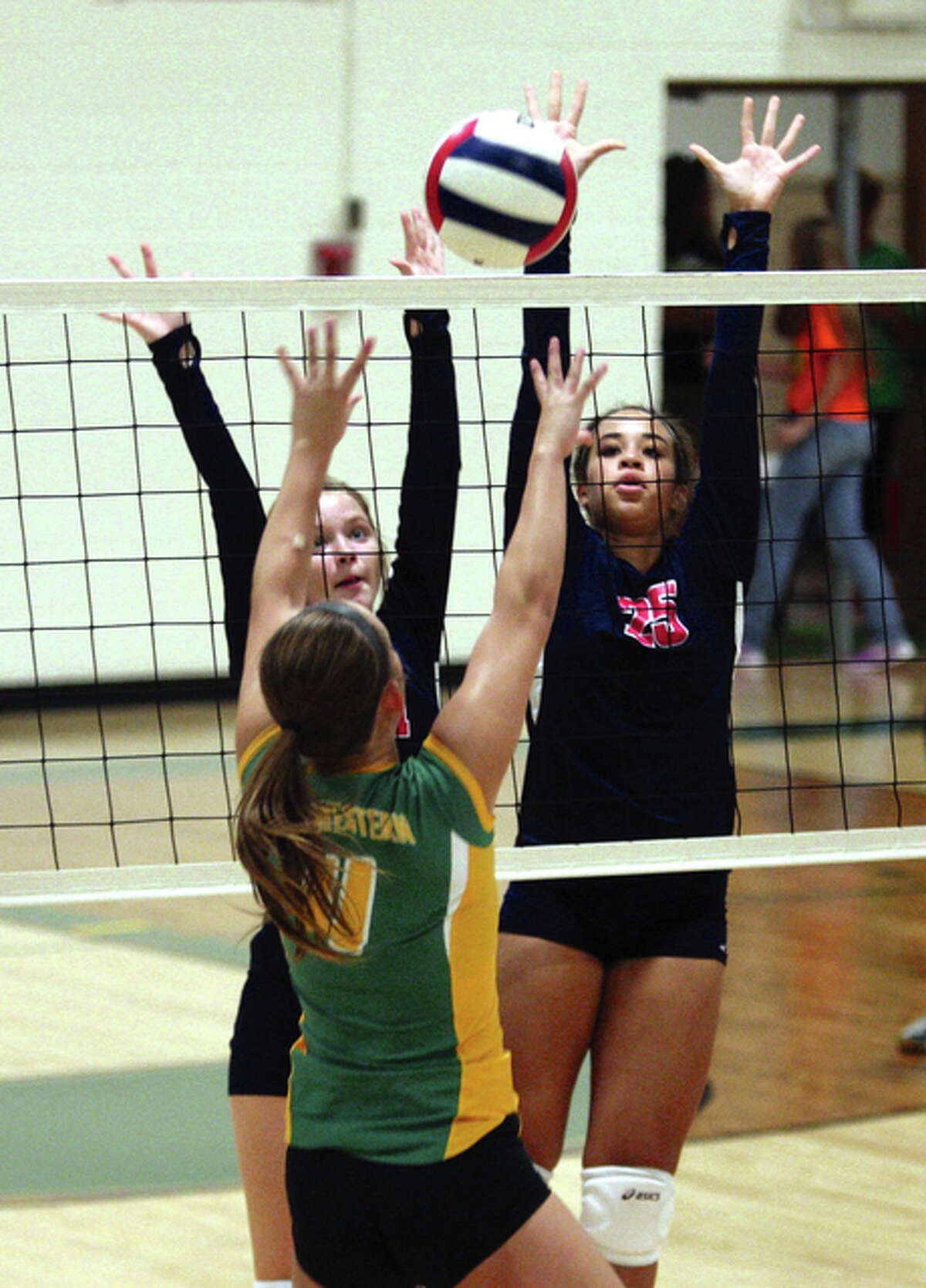 Southwestern’s Jenna Moore (front) pushes the ball past the double block put up by Carlinville’s Sydney Bates (left) and Anna Chew (right) during a SCC match Sept. 15 in Piasa. The Piasa Birds and Cavaliers meet for a fourth time — Southwestern won two of the three previous matches — on Thursday for the championship of the Carlinville Class 2A Regional.
