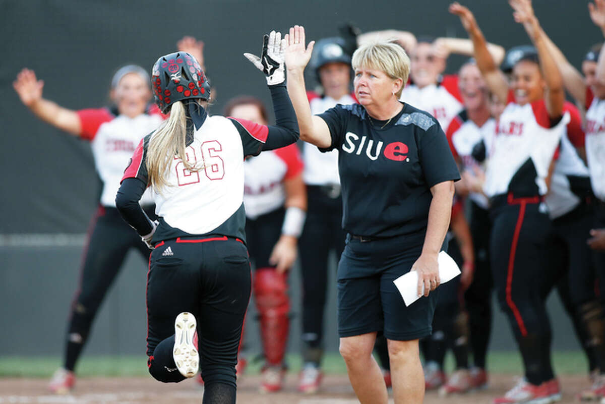 SIUE softball coach Sandy Montgomery (right) celebrates a home run during a game last season at Cougar Field in Edwardsville.