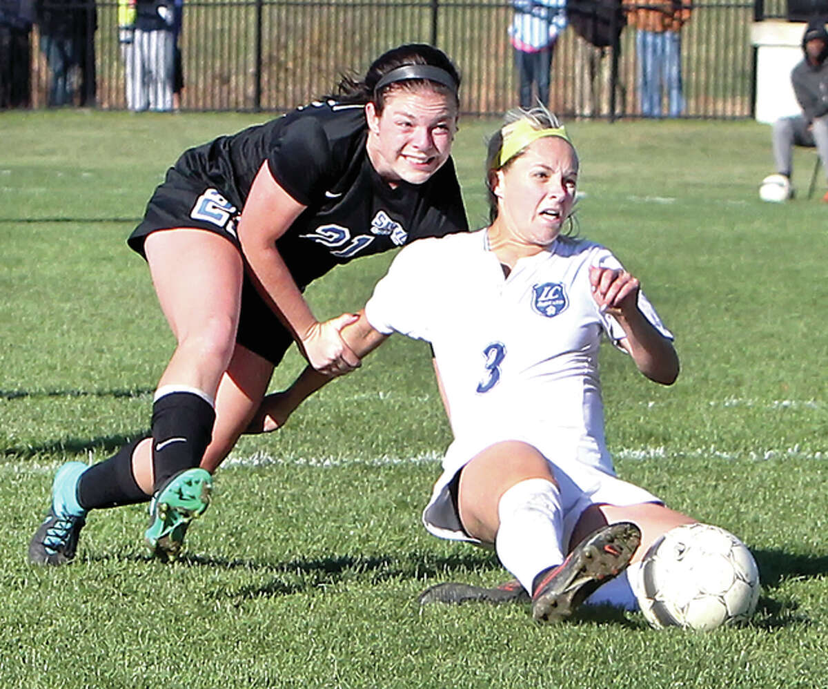 LCCC’s Nicole Howard (3) scores the game-winning goal, despite being grabbed by Southwestern Illinois College defender Allison Pritchard in Thursday’s Region 24 semifinal game at LCCC.