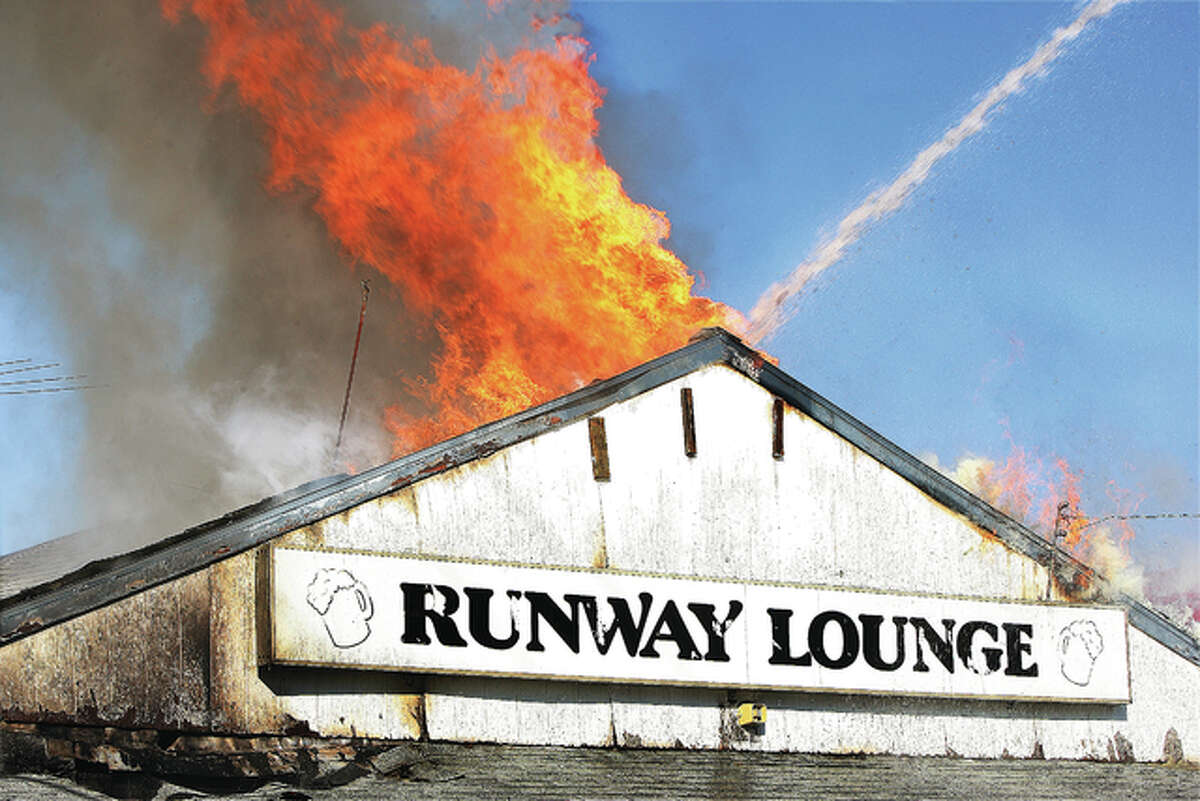 Flames roar from the roof of the Runway Lounge, 314 W. Bethalto Drive, also known as Illinois Route 140, Tuesday shortly after 1 p.m. Firefighters from Bethalto, Rosewood Heights and Alton battled the blaze but the entire front portion of the structure was extensively damaged. No injuries were reported.