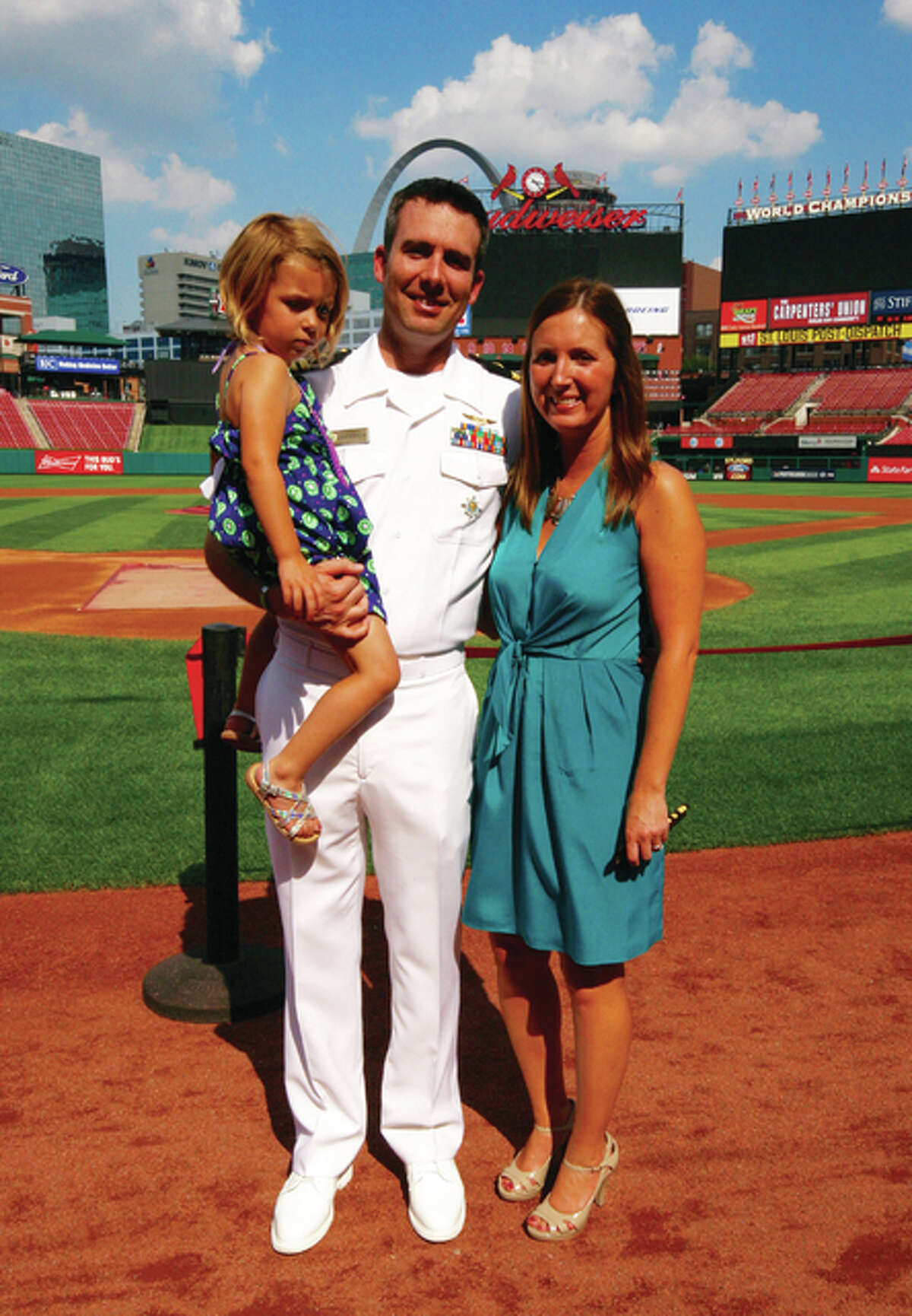 Nathan Rockholm with his wife, Kelly, and stepdaughter, A. J. at his U.S. Navy promotion ceremony at Busch Stadium in September.