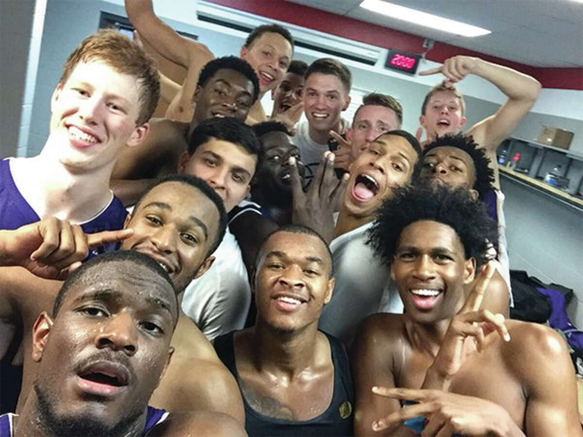 Garret Covington (lower left) takes a selfie with teammates in the locker room while celebrating Western Illinois’ upset of No. 17 Wisconsin on Friday night at Madison, Wis. Covington, a junior from Edwardsville, scored 16 points and converted the game-winning free throws with 10 seconds left in the game.