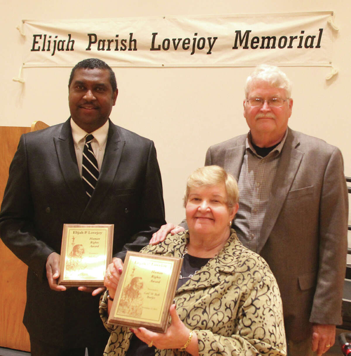 The Rev. Michael Logan, left, Gail Burjes and Robert Burjes received Lovejoy Human Rights Awards at the Elijah P. Lovejoy Memorial Annual Dinner, held Friday.