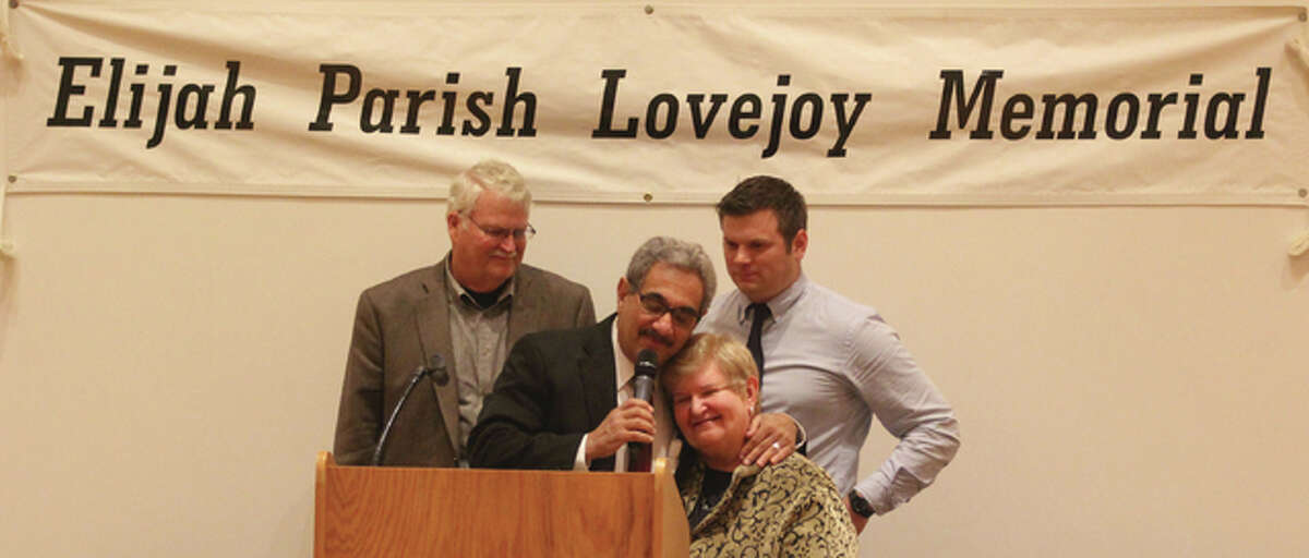 Robert Burjes, left, presenter Philip Trapani, Gail Burjes and Chris Williams share a moment as the Burjes’ receive a Lovejoy Human Rights Award at the Elijah P. Lovejoy Memorial Annual Dinner, held Friday in the Hatheway Cultural Center at Lewis and Clark Community College in Godfrey.