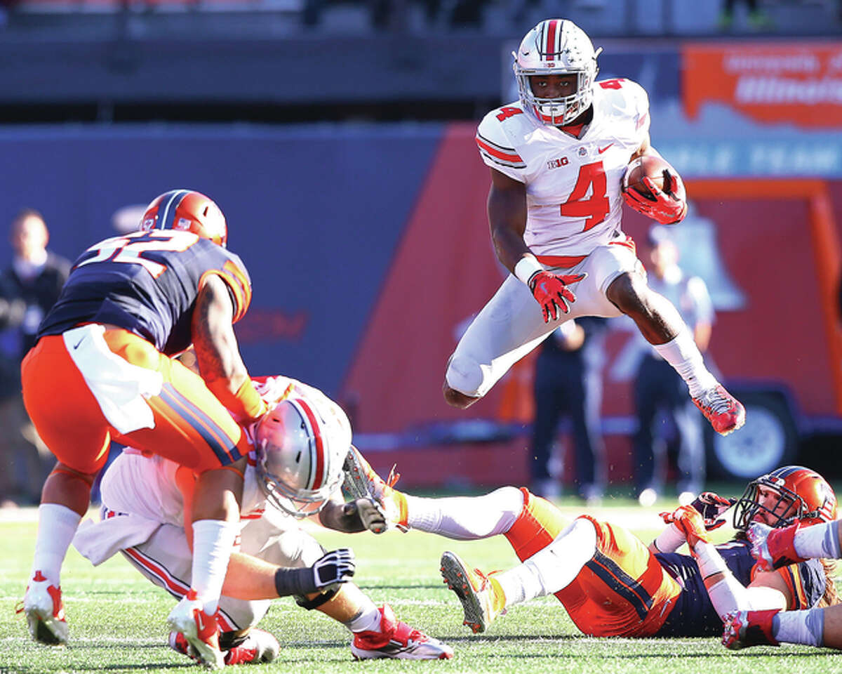 Ohio State running back Curtis Samuel (4) hurdles over Illinois defensive back Taylor Barton during the second half of the Buckeyes’ Big Ten Conference victory Saturday at Memorial Stadium in Champaign.