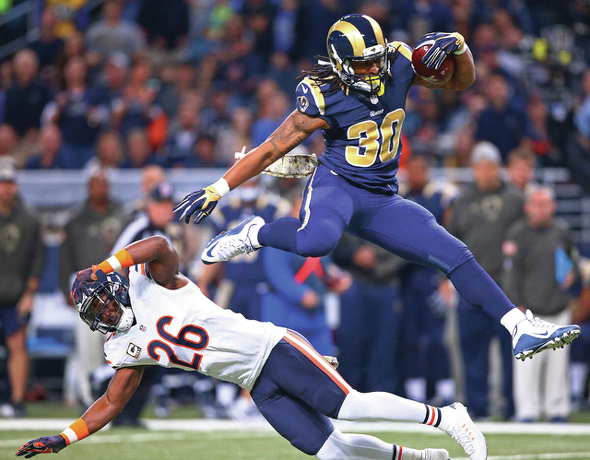 Rams running back Todd Gurley (right) leaps over Bears safety Antrel Rolle during the first half Sunday at the Edward Jones Dome in St. Louis.