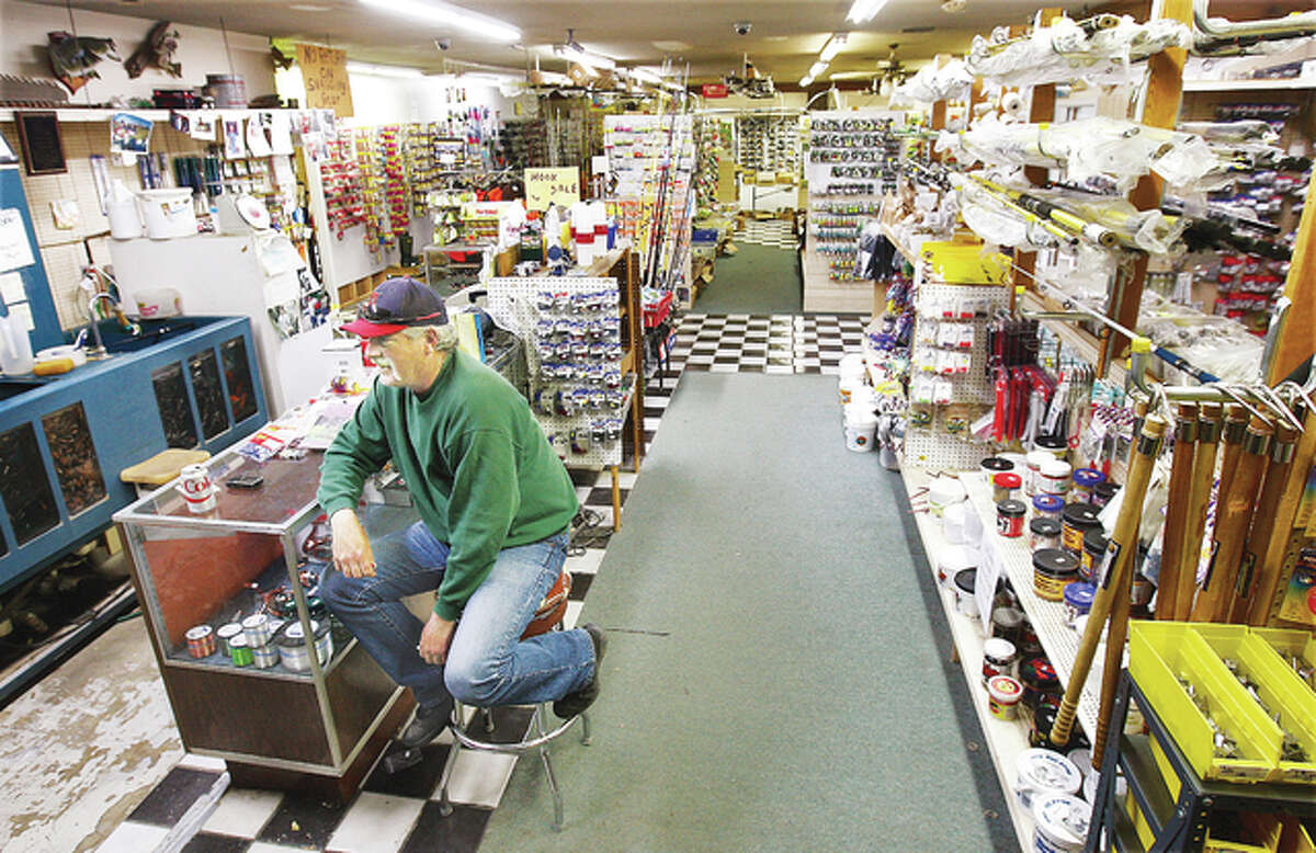 A customer enjoys a soda inside Bluff City Tackle, 2813 E. Broadway in Alton, where the fishing business is also a place for sportsmen to hang out and talk. The nearly-landmark Alton business is closing.